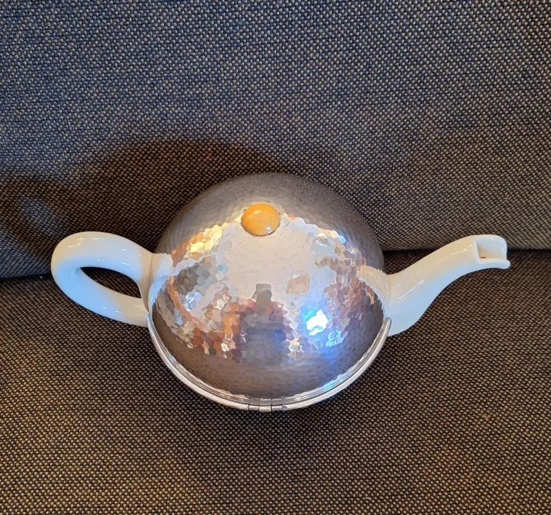 New Pamono Vintage Art Deco German Cream-white Porcelain Spherical Teapot with Silver-Plated Thermal Jacket and Yellow-Brown Bakelite Feet from WMF, 1940s